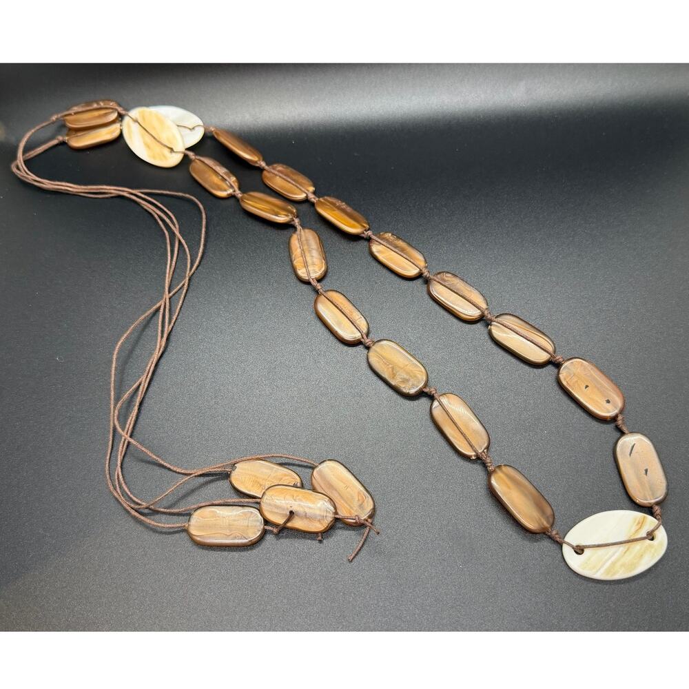 Fashion Jewelry strand necklace featuring flat oval Browm/cream